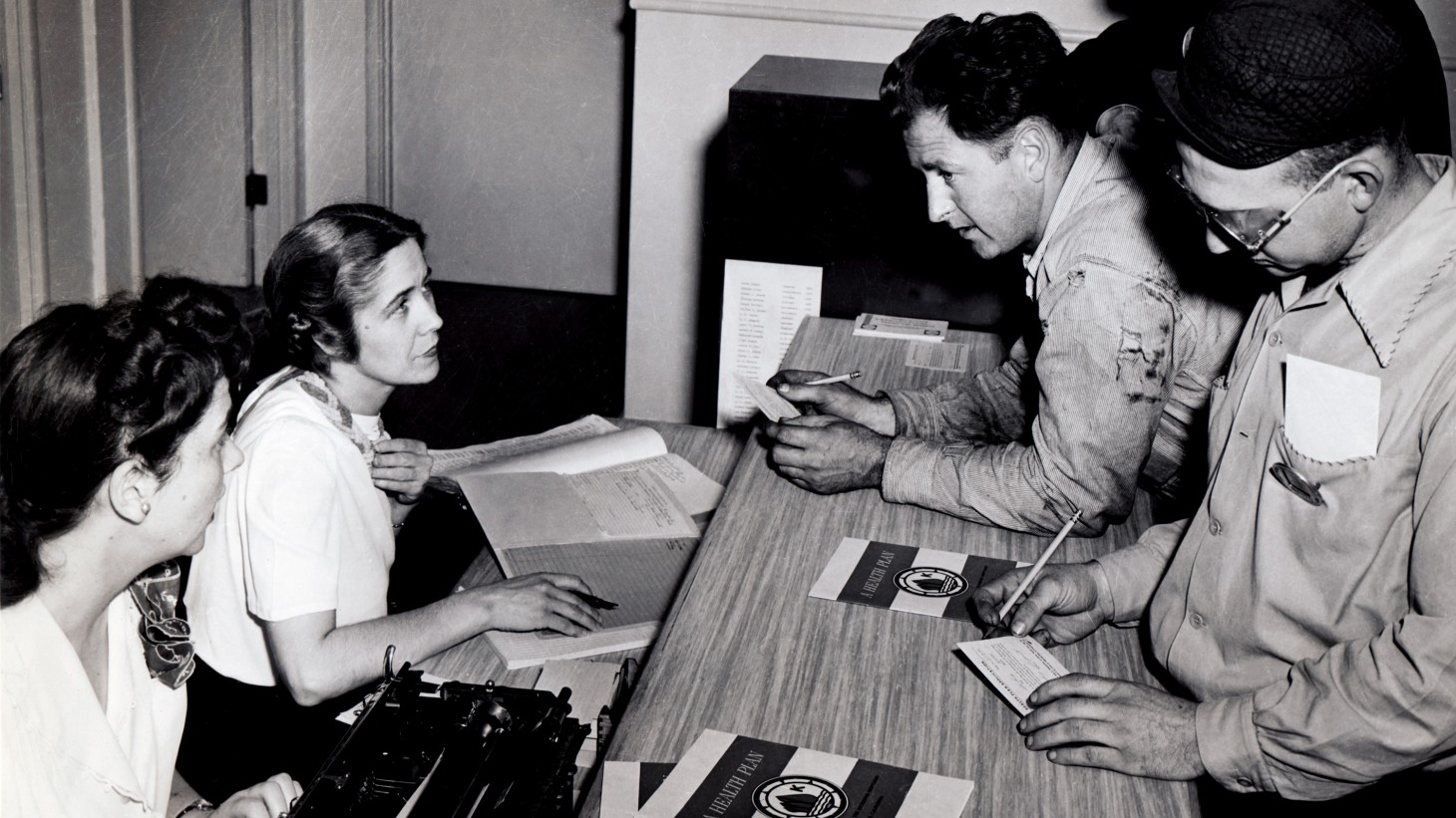 Shipyard workers in 1942 signing up for health care coverage 