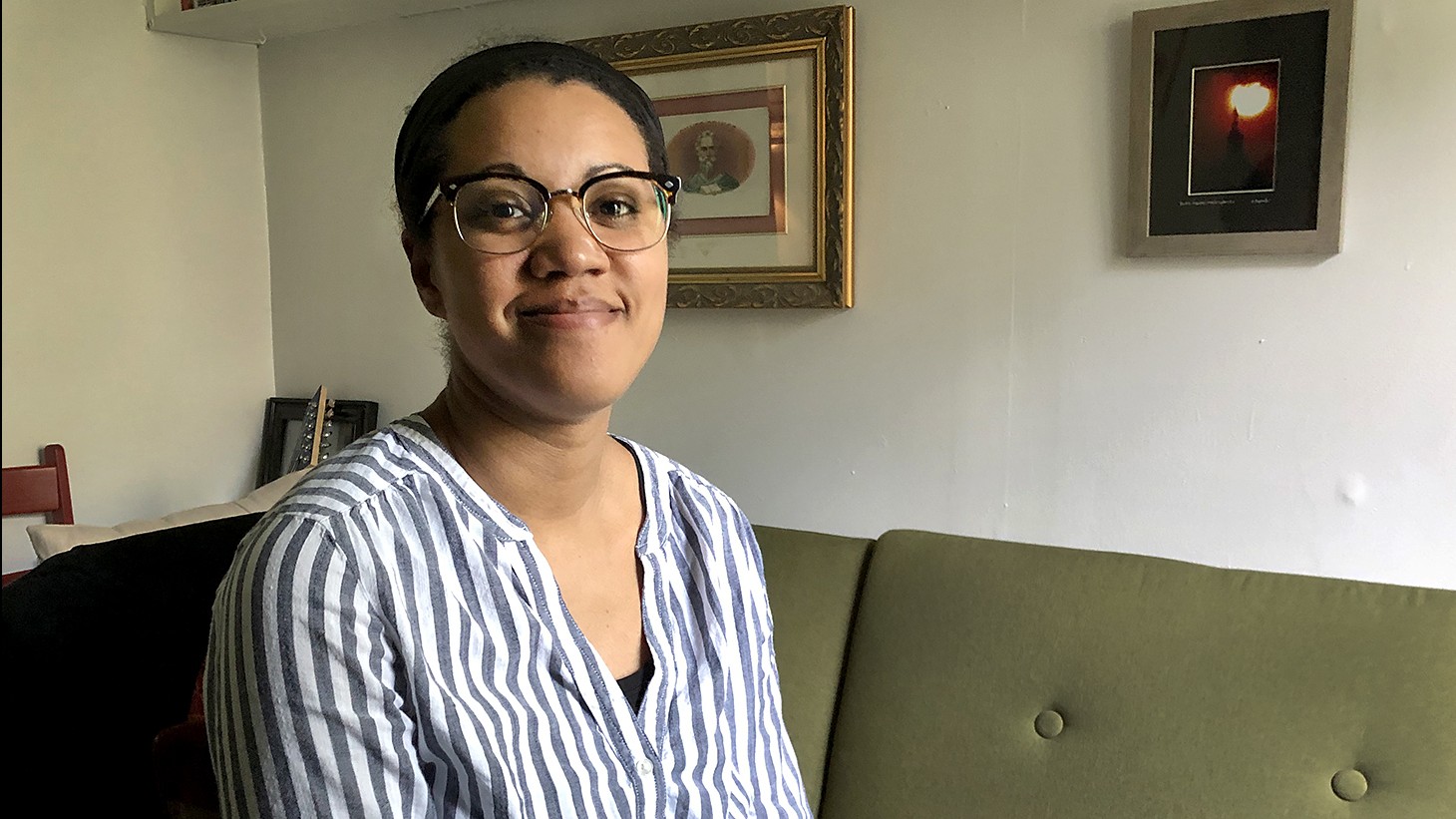 Portrait of a Black woman, green couch