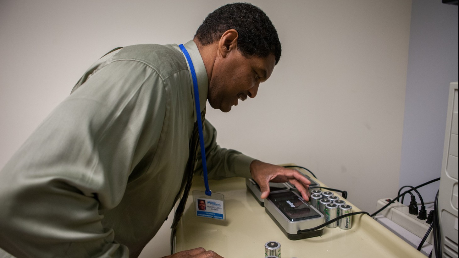 man with battery recycling device 