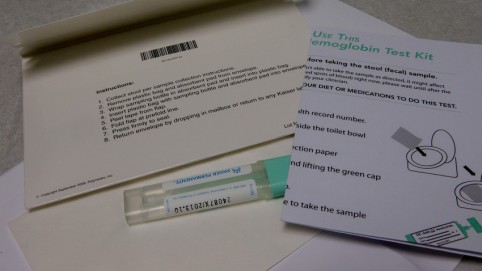 Envelope, test tube and instructions for a FIT kit 