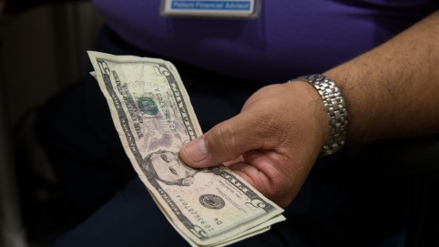 Man's hands holding cash 