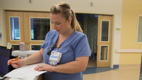 Nurse filling out paperwork.