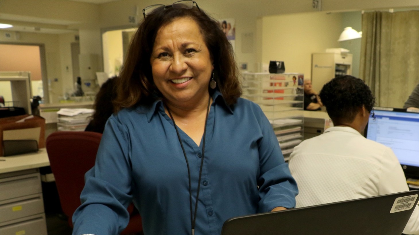 health care worker at computer on wheels