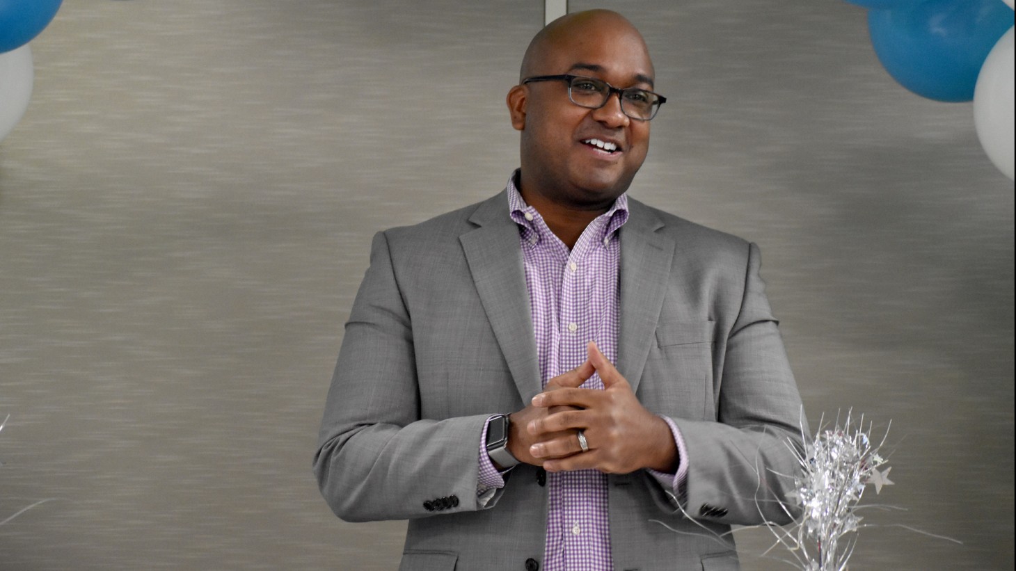 African American man wearing a sport coat, talking 