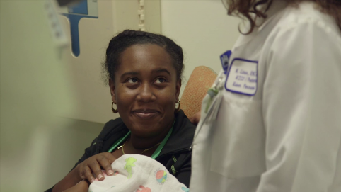 Mother with baby and care provider in the NICU 